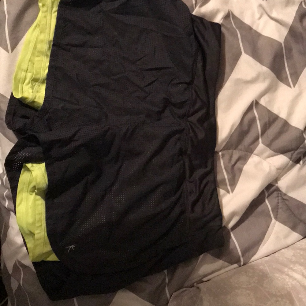 Dark grey and lime green athletic shorts.